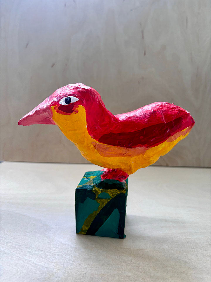 Paper mache red bird statue