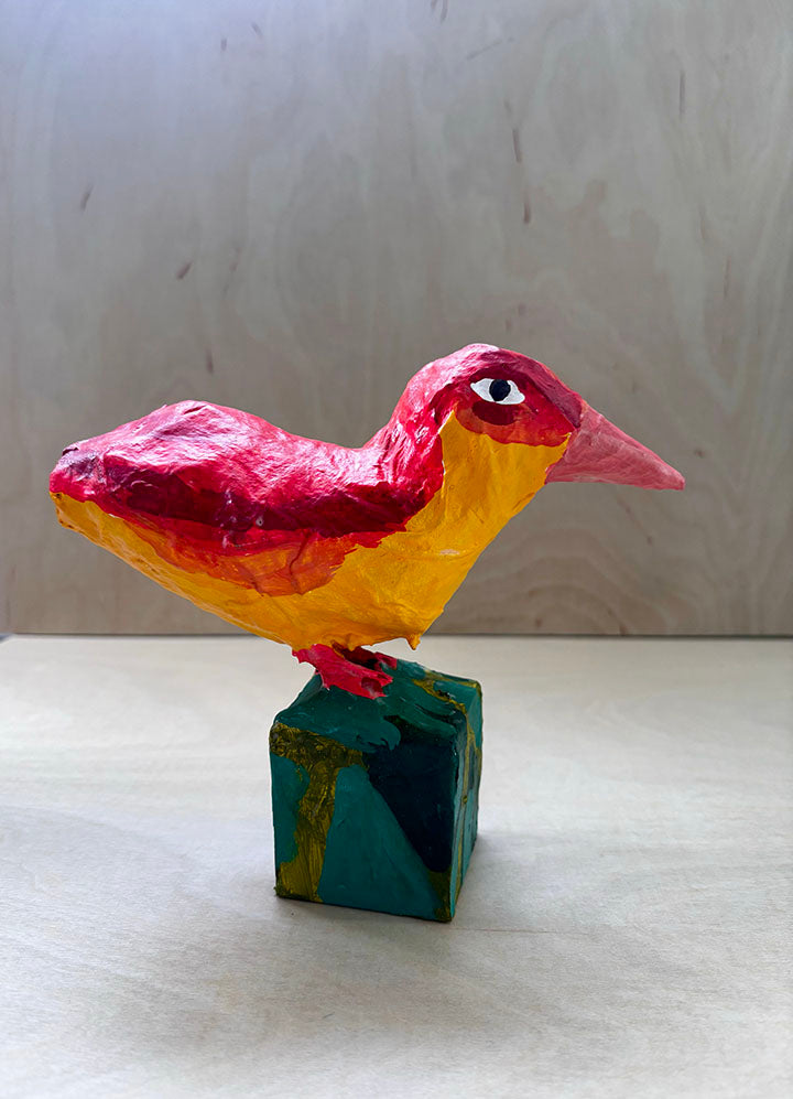 Paper mache red bird statue