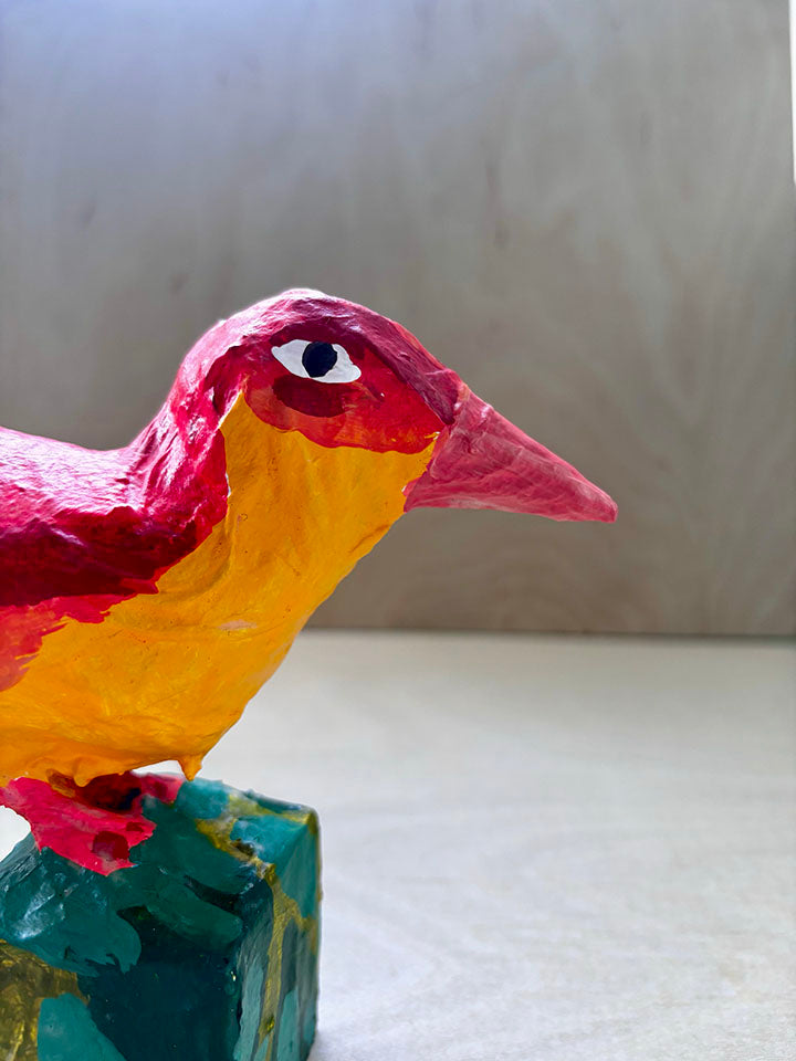 Paper mache red bird statue