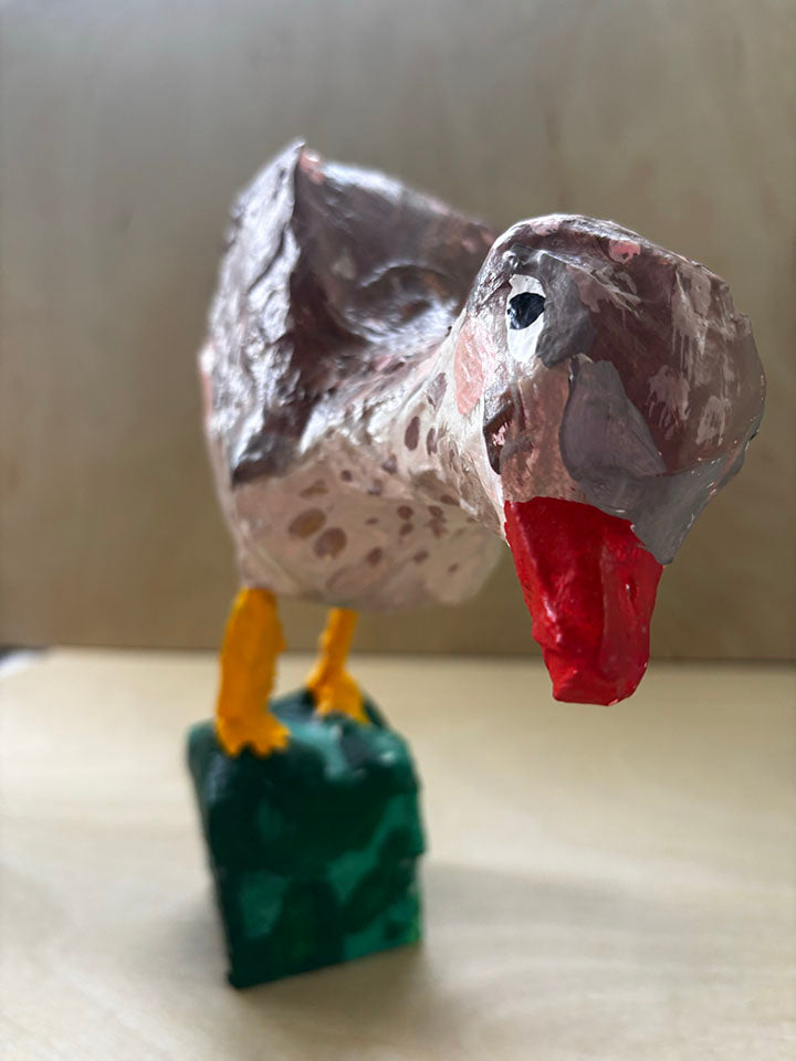 Paper mache bird statue